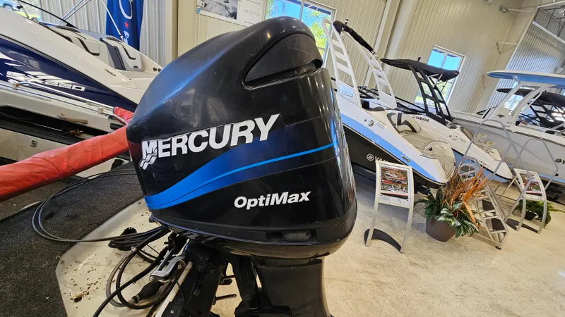 Slide: The Image of Mercury OptiMax outboard motor in a showroom with boats, Warrior 1898 DC, year 2000. - 19