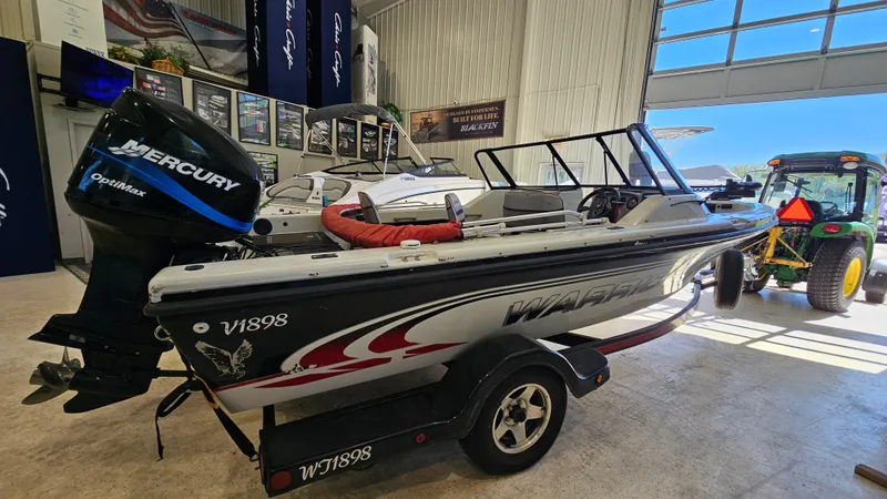 Slide: The Image of 2000 Warrior 1898 DC boat with Mercury Optimax engine in a showroom. - 3