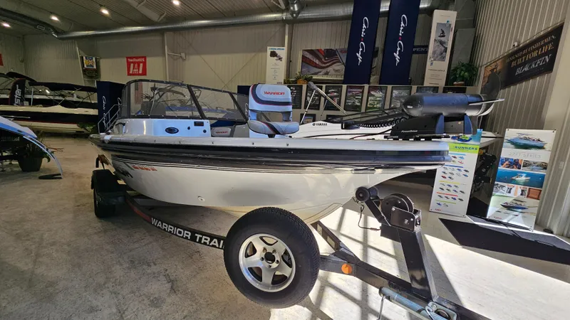 Slide: The Image of Boat showroom featuring a 2000 Warrior 1898 DC on a trailer. - 4