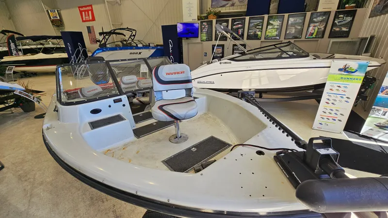 Slide: The Image of Boat showroom featuring a 2000 Warrior 1898 DC model on display. - 5