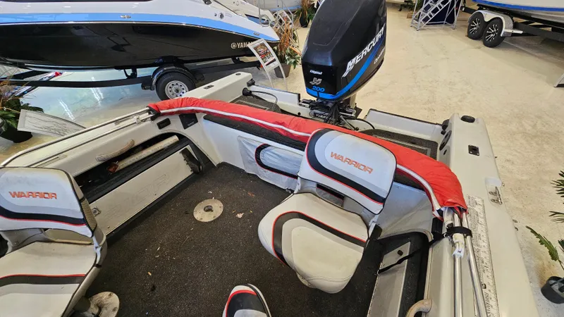 Slide: The Image of Interior of a 2000 Warrior 1898 DC boat with seating and motor. - 9