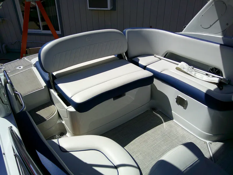 Slide: The Image of 2021 Crownline 255 SS boat interior with white and blue seating. - 11