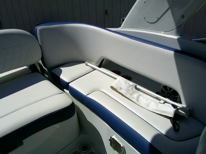 Slide: The Image of 2021 Crownline 255 SS boat interior with white and blue seating. - 13