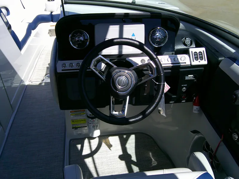 Slide: The Image of 2021 Crownline 255 SS boat dashboard with steering wheel and control panel. - 15