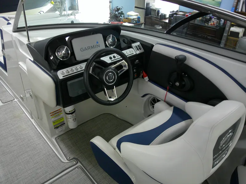 Slide: The Image of 2021 Crownline 255 SS boat cockpit with Garmin navigation system and modern steering wheel. - 20