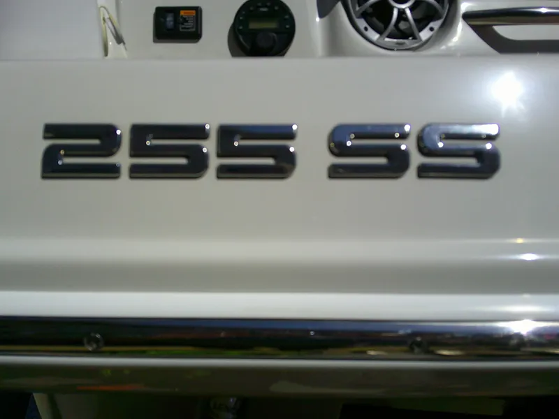 Slide: The Image of 2021 Crownline 255 SS boat emblem with chrome lettering and dashboard details. - 21