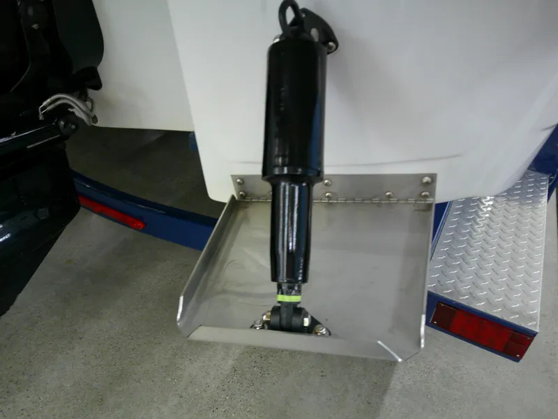 Slide: The Image of Trim tab of 2021 Crownline 255 SS boat, featuring hydraulic actuator and stainless steel construction. - 22