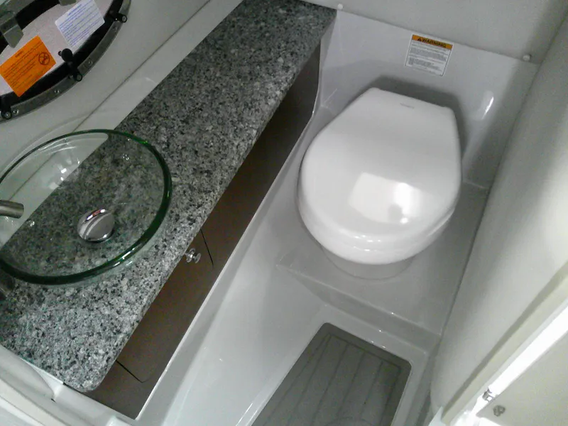 Slide: The Image of 2021 Crownline 255 SS boat bathroom with modern sink and toilet. - 24