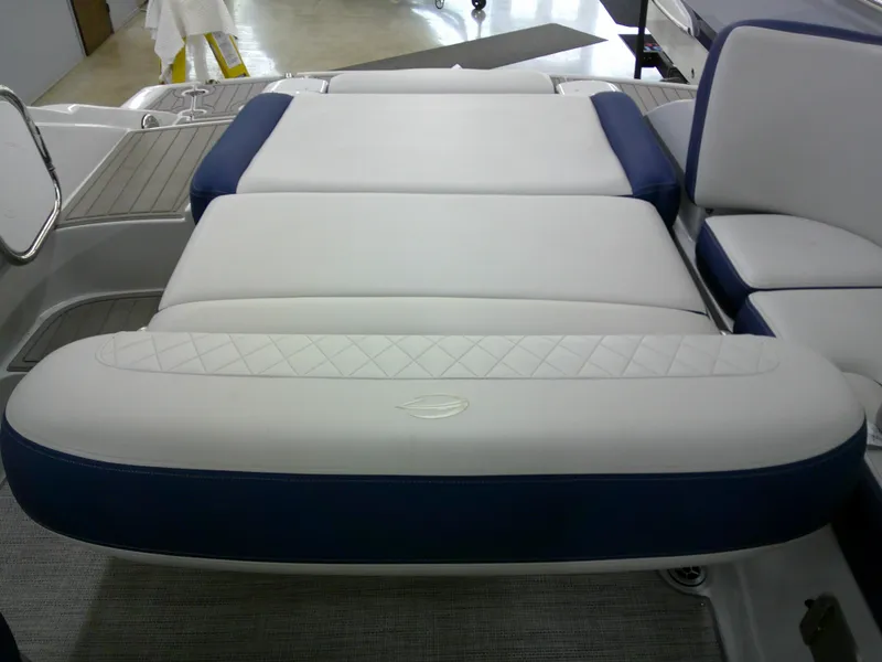 Slide: The Image of 2021 Crownline 255 SS boat interior with white and blue cushioned seating. - 5