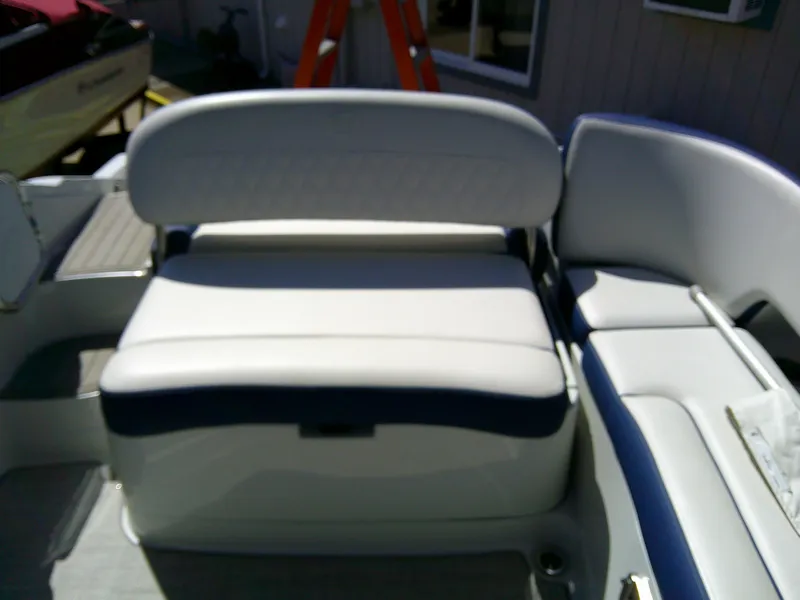 Slide: The Image of 2021 Crownline 255 SS boat interior seating with white and blue upholstery. - 7