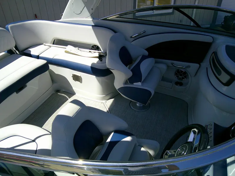 Slide: The Image of 2021 Crownline 255 SS boat interior with plush seating and modern dashboard. - 8