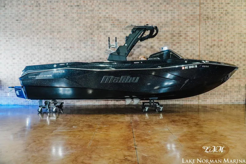 Slide: The Image of 2023 Malibu 26 LSV boat displayed indoors at Lake Norman Marina. - 1