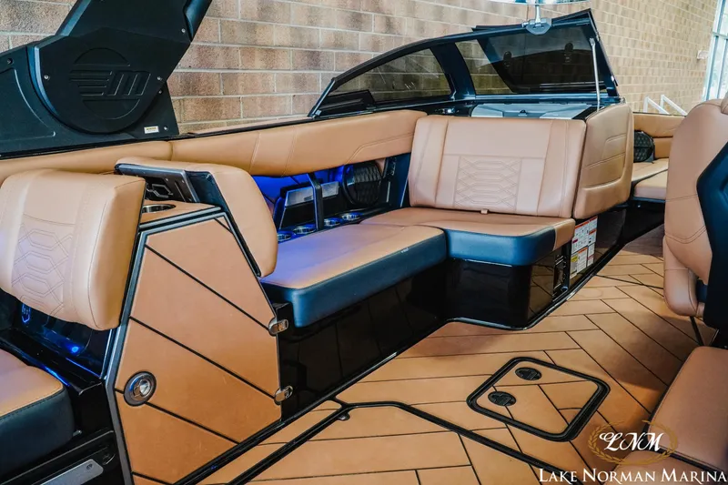 Slide: The Image of 2023 Malibu 26 LSV boat interior with tan leather seating and modern design. - 19