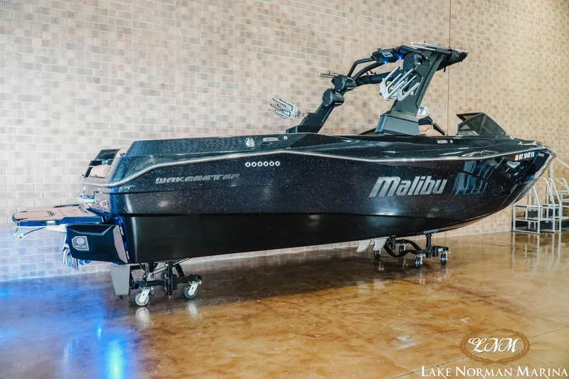 Slide: The Image of 2023 Malibu 26 LSV boat displayed indoors at Lake Norman Marina. - 2