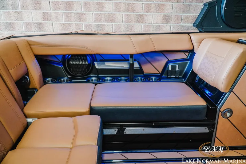 Slide: The Image of 2023 Malibu 26 LSV interior with tan leather seats and blue LED lighting. - 20