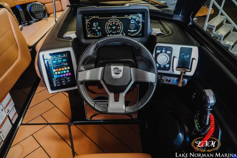 Slide: The Image of 2023 Malibu 26 LSV boat dashboard with advanced controls and digital displays. - 22