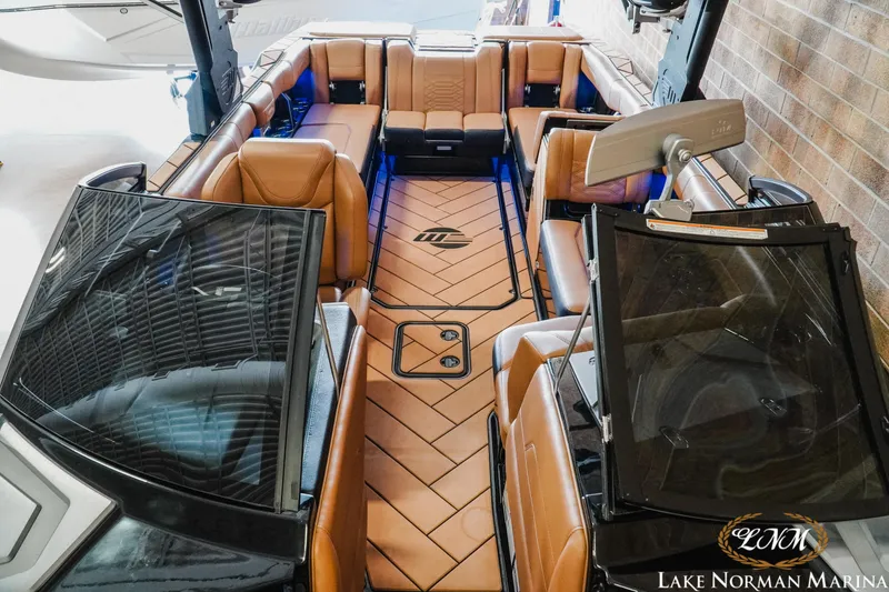 Slide: The Image of 2023 Malibu 26 LSV boat interior with tan leather seating and sleek design at Lake Norman Marina. - 25
