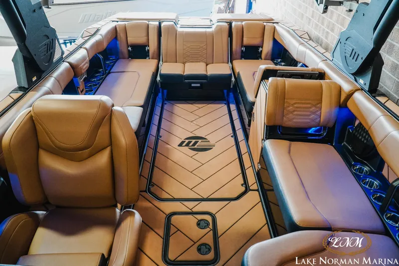 Slide: The Image of Luxurious interior of 2023 Malibu 26 LSV boat with tan leather seating. - 26