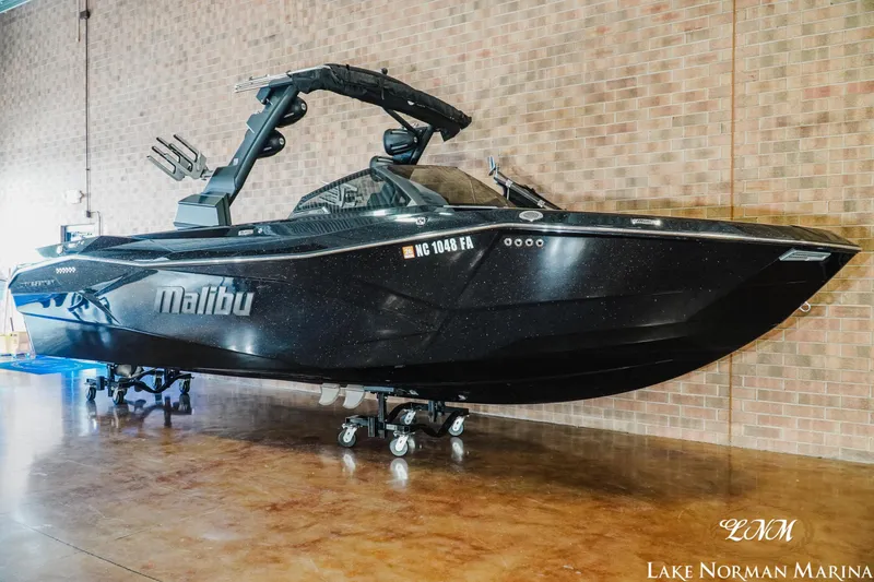Slide: The Image of 2023 Malibu 26 LSV boat displayed indoors at Lake Norman Marina. - 3
