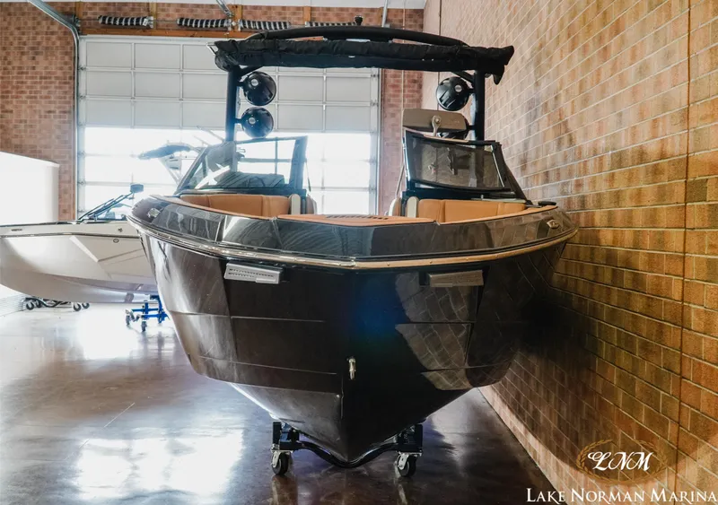Slide: The Image of 2023 Malibu 26 LSV boat displayed indoors at Lake Norman Marina. - 4