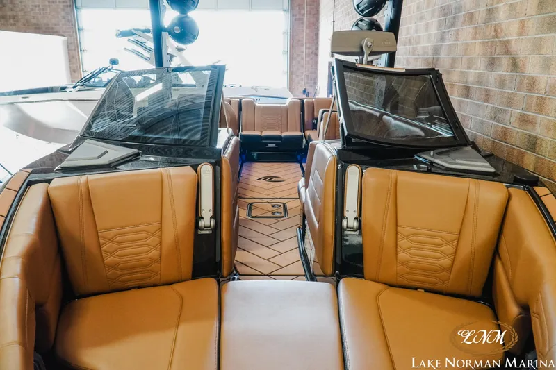 Slide: The Image of 2023 Malibu 26 LSV boat interior with tan leather seats at Lake Norman Marina. - 6