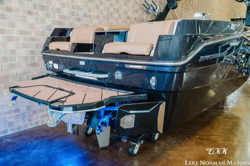 Slide: The Image of 2023 Malibu 26 LSV boat with sleek design and illuminated swim platform at Lake Norman Marina. - 7