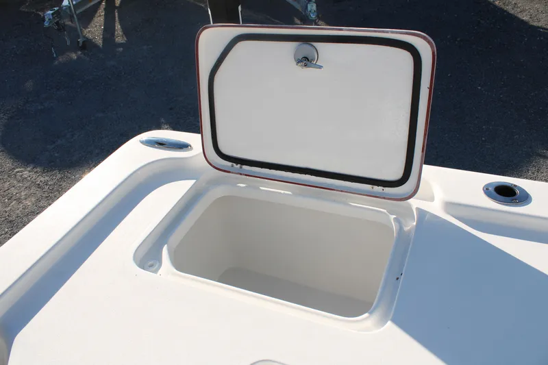 Slide: The Image of 2024 Sea Pro 250 Bay boat storage compartment with open lid, showcasing interior space. - 14
