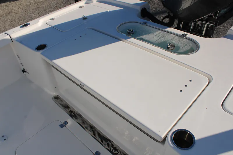 Slide: The Image of 2024 Sea Pro 250 Bay boat deck with storage compartments and livewell. - 18