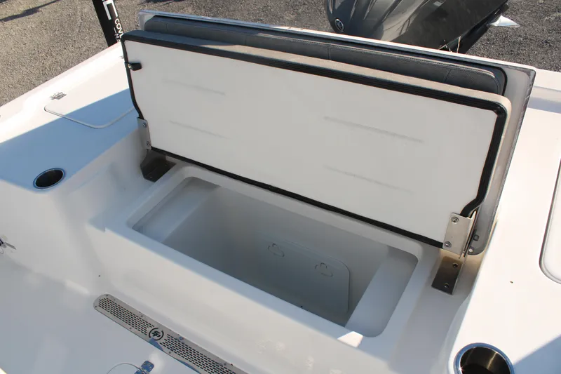 Slide: The Image of 2024 Sea Pro 250 Bay boat storage compartment with open lid, showcasing spacious interior. - 19