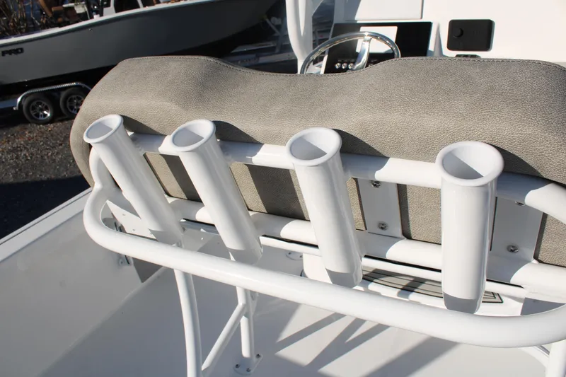 Slide: The Image of 2024 Sea Pro 250 Bay boat with rod holders and cushioned seating. - 23