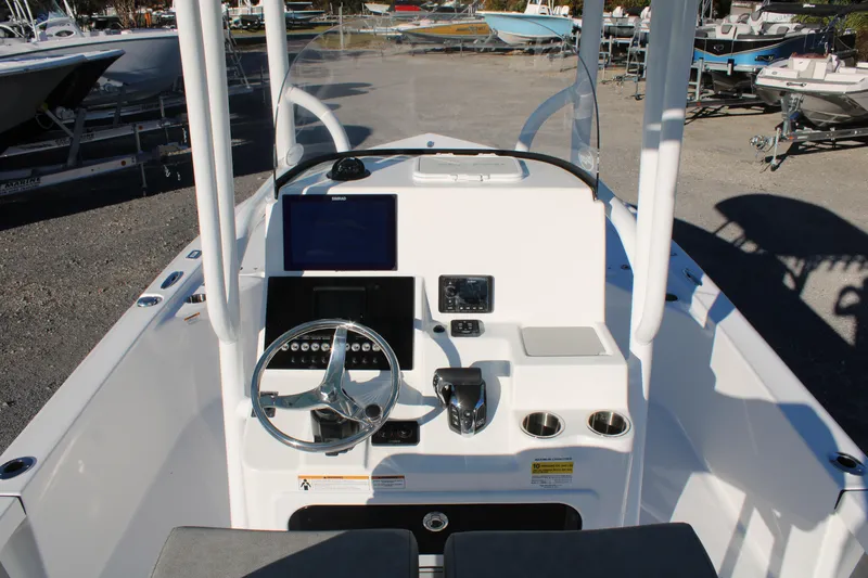 Slide: The Image of 2024 Sea Pro 250 Bay boat console with steering wheel and navigation screens. - 25