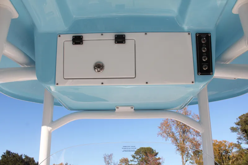 Slide: The Image of 2024 Sea Pro 250 Bay boat console with storage compartment and control panel. - 27