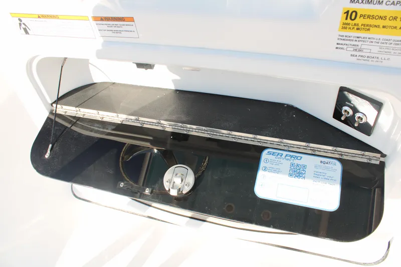 Slide: The Image of 2024 Sea Pro 250 Bay boat dashboard with capacity and safety labels. - 28