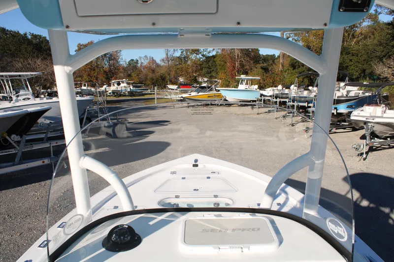 Slide: The Image of 2024 Sea Pro 250 Bay boat in a marina, surrounded by other boats. - 29