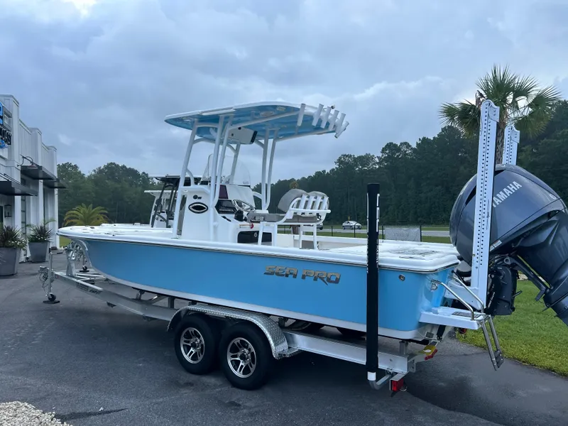 Slide: The Image of 2024 Sea Pro 250 Bay boat on trailer, featuring Yamaha engine, parked outdoors. - 3
