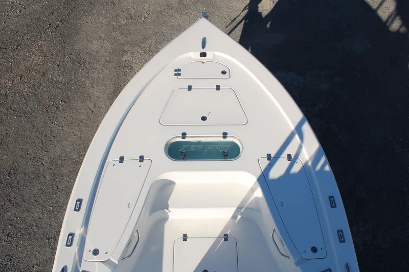 Slide: The Image of 2024 Sea Pro 250 Bay boat deck, top view, showcasing storage compartments and sleek design. - 32