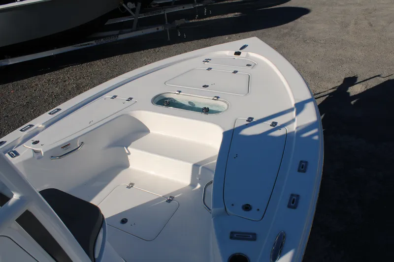 Slide: The Image of 2024 Sea Pro 250 Bay boat deck with storage compartments and seating. - 33