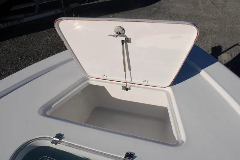 Slide: The Image of 2024 Sea Pro 250 Bay boat storage compartment with open hatch, showcasing interior space. - 34