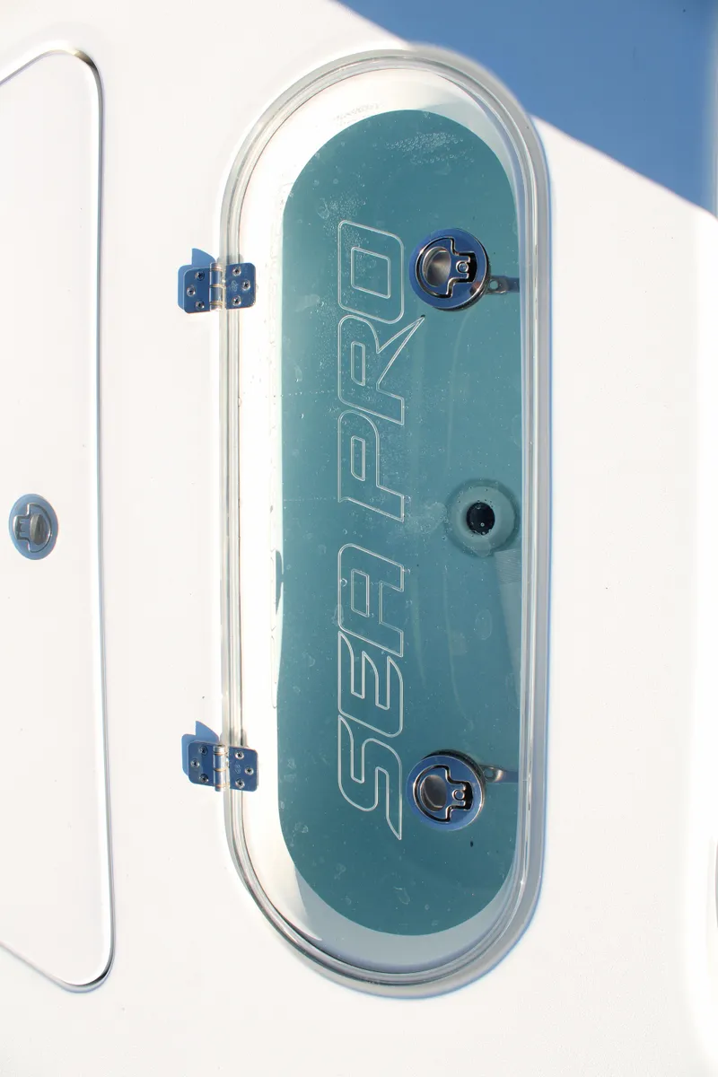 Slide: The Image of 2024 Sea Pro 250 Bay boat detail with logo on a sleek surface. - 36