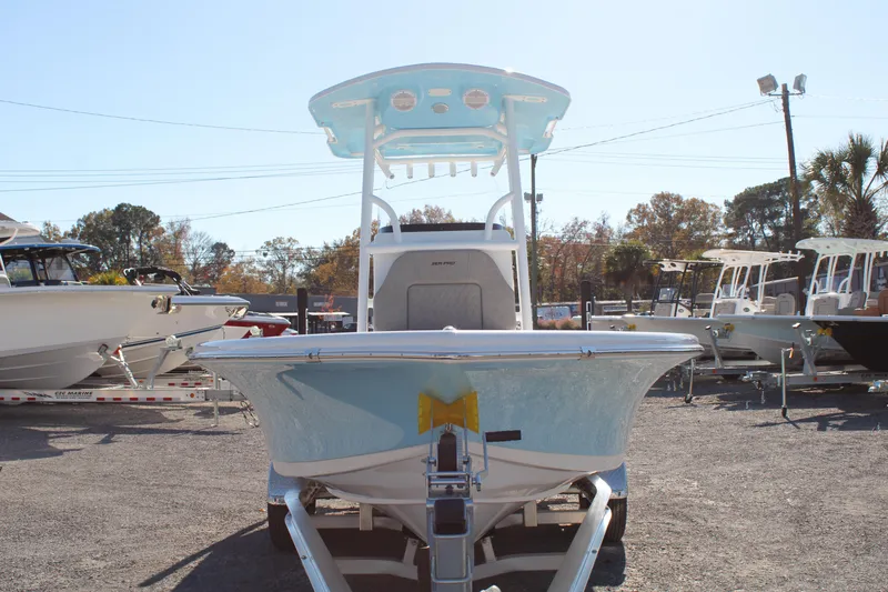 Slide: The Image of 2024 Sea Pro 250 Bay boat on trailer, displayed outdoors in a marina setting. - 4