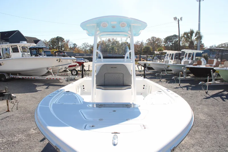 Slide: The Image of 2024 Sea Pro 250 Bay boat displayed in a marina, showcasing sleek design and spacious deck. - 6