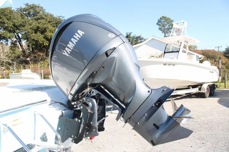 Slide: The Image of 2024 Sea Pro 250 Bay boat with Yamaha outboard motor, parked outdoors. - 7