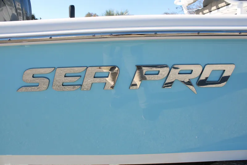 Slide: The Image of 2024 Sea Pro 250 Bay boat logo on light blue hull. - 9