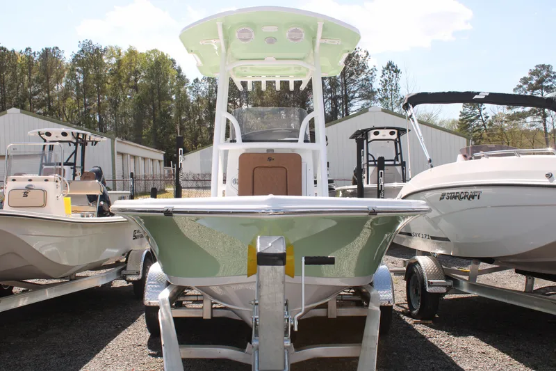 Slide: The Image of 2024 Sea Pro 210 boat on trailer, surrounded by other boats, in a dealership lot. - 10