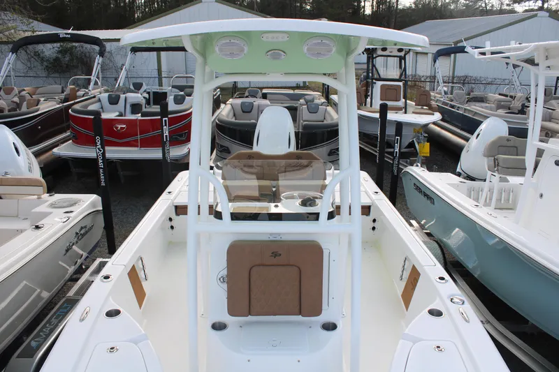 Slide: The Image of 2024 Sea Pro 210 boat with center console, displayed among other boats in a marina. - 7