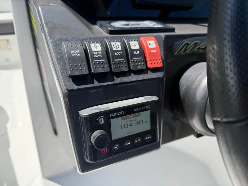 Slide: The Image of Control panel of a 2018 Monterey M-45 boat with switches and a Fusion stereo. - 14