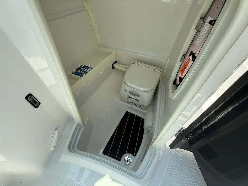 Slide: The Image of Interior of a 2018 Monterey M-45 boat featuring a compact marine toilet. - 18