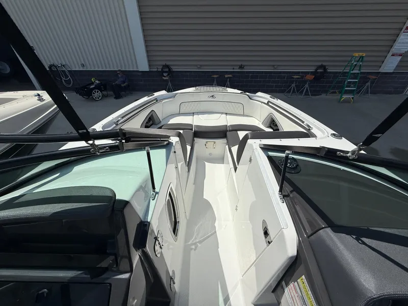 Slide: The Image of 2018 Monterey M-45 boat interior with seating and open deck, docked near a building. - 19