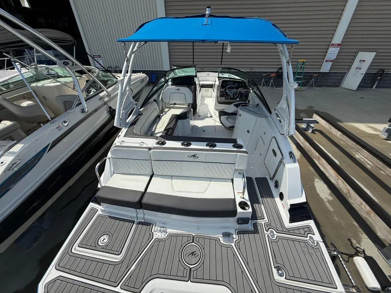 Slide: The Image of 2018 Monterey M-45 boat with blue canopy, docked at marina. - 4