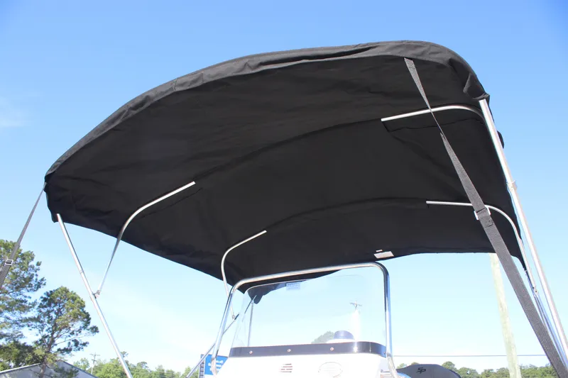 Slide: The Image of 2024 Sea Pro 202 CC boat with black canopy under clear blue sky. - 11
